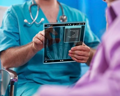 A picture of medical staff holding hand x-ray result