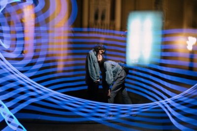 Couple cuddling surrounded by blue light stripes