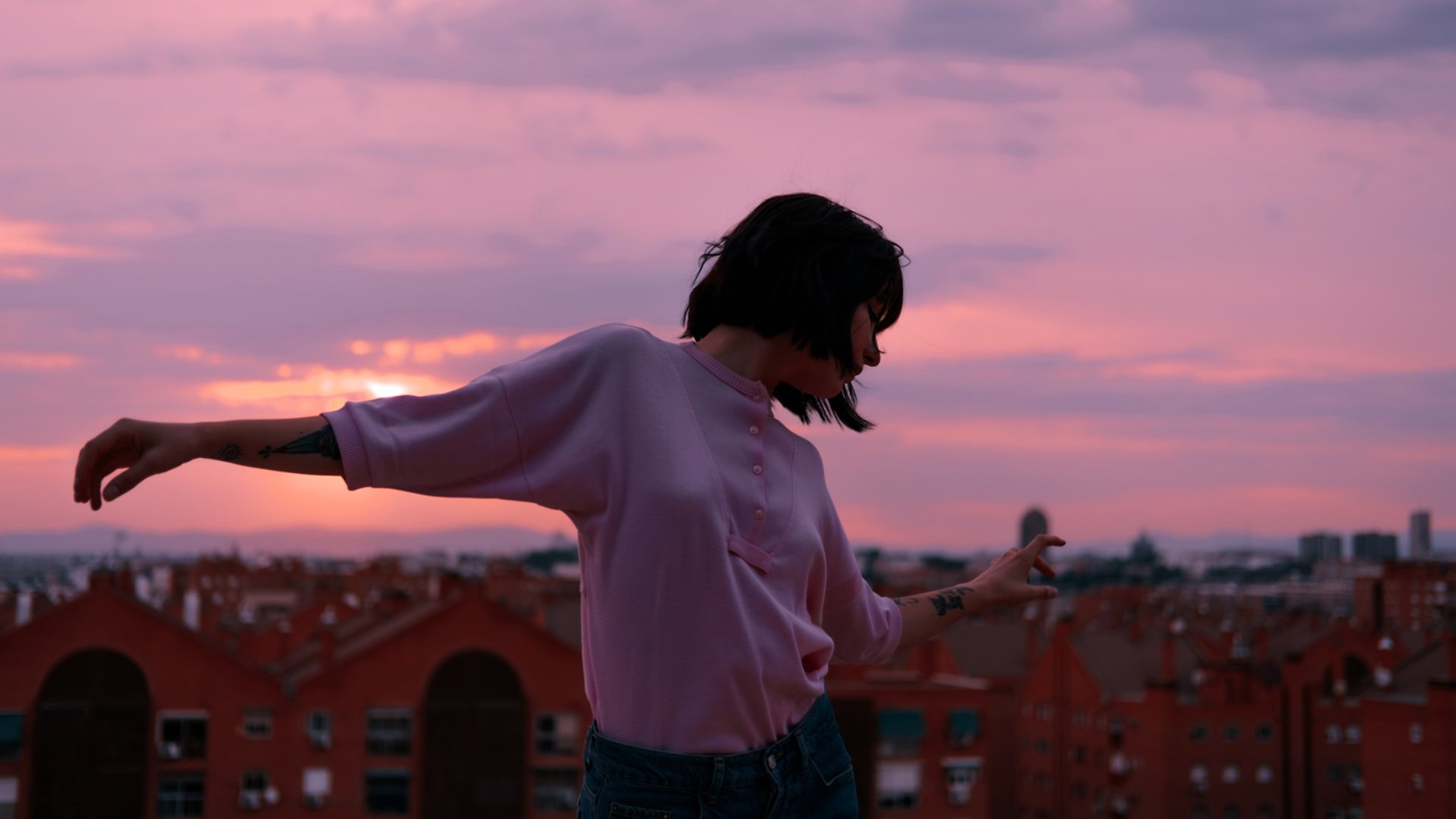 woman with outstretched arms at sunset