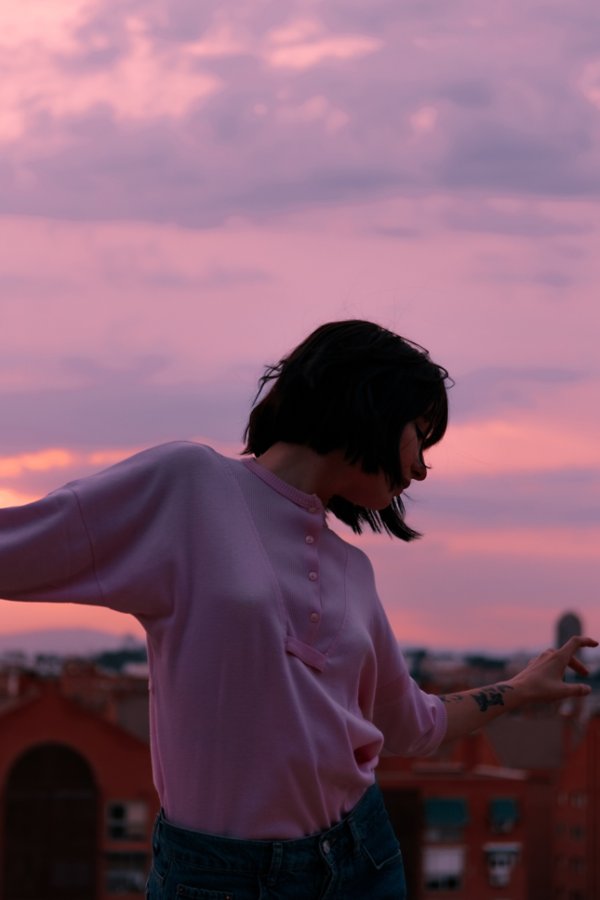 Woman with outstretched arms at sunset