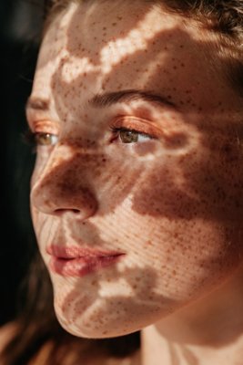 Girl with random floral shadows on her face