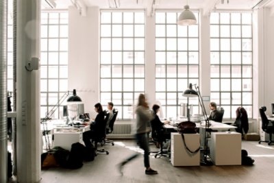 A blurry person walking in the office