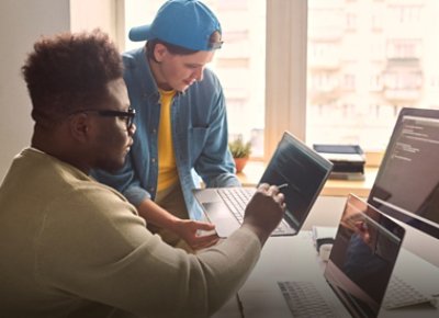 Men discussing code in front of computers