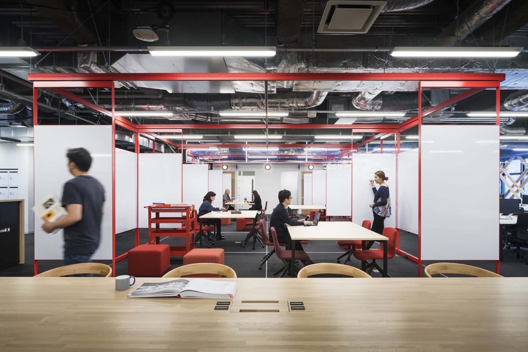 An office with office workers walking and talking with each other