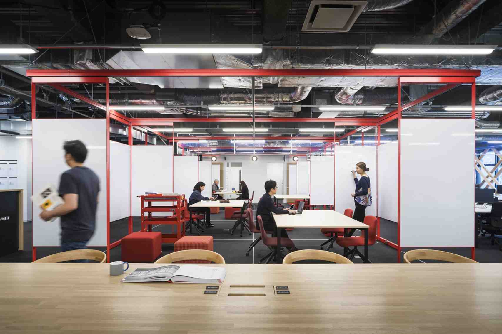 An office with office workers walking and talking with each other