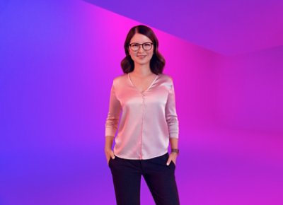 A woman wearing glasses posing