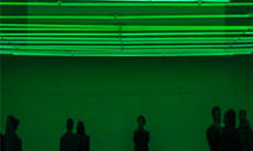 People in green-lit room