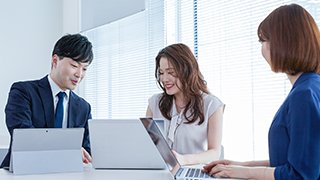 Three people discussing in the office