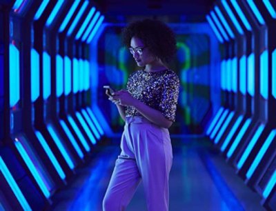 A woman holding her phone inside the tunnel