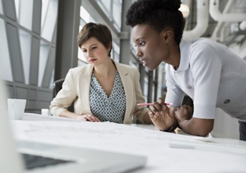 Two workers collaborating in office