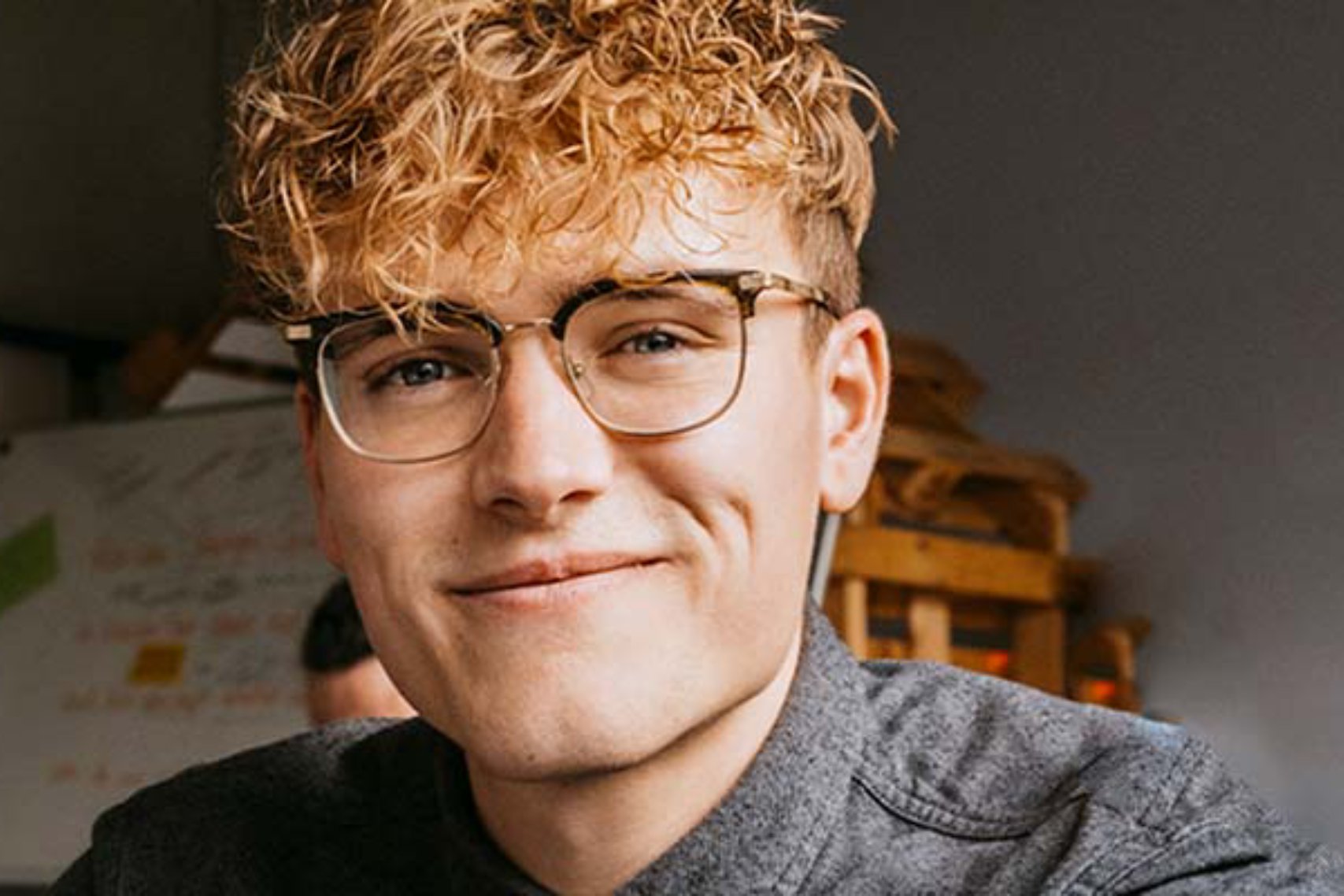 Blonde curly haired man with glasses