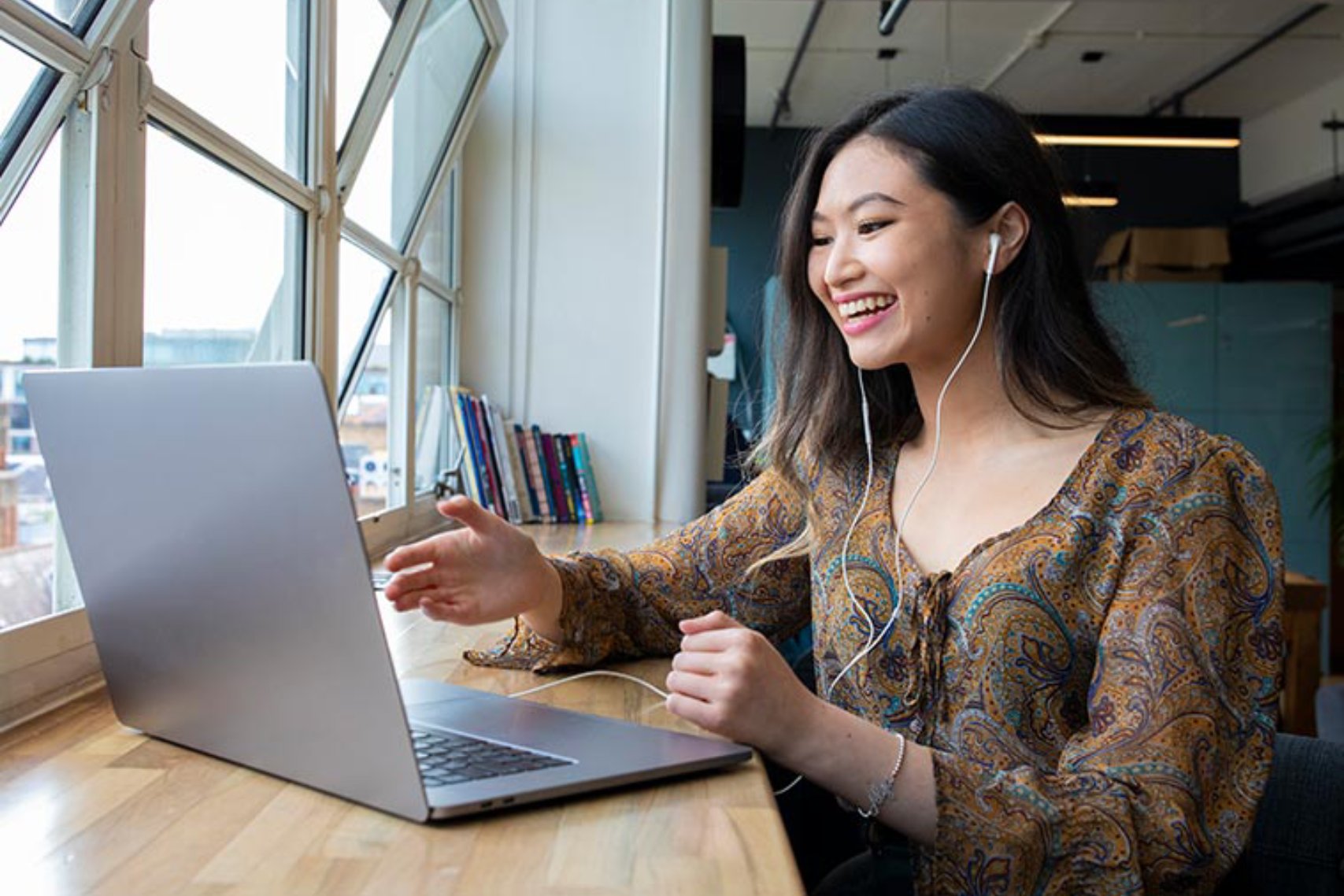 Woman smiling in front of laptop