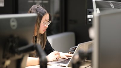 student working on her laptop