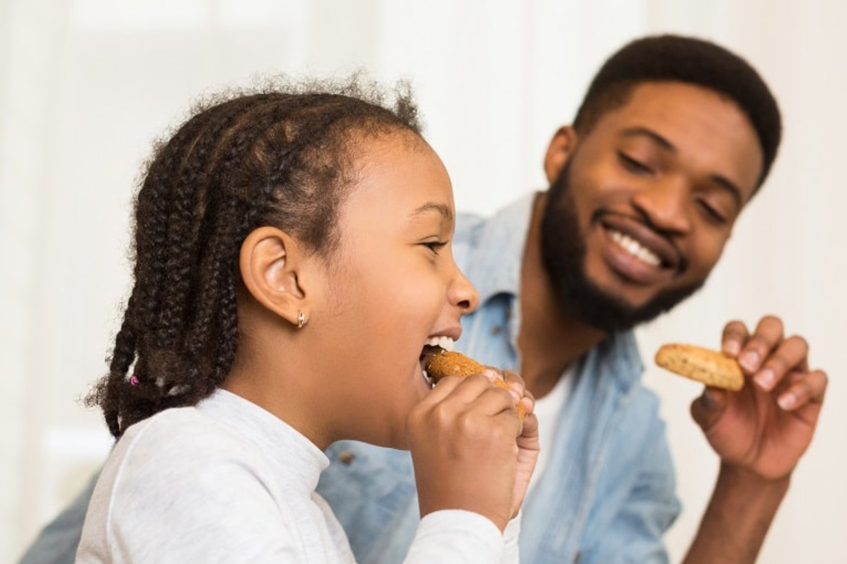 A man and a kid eating cookies