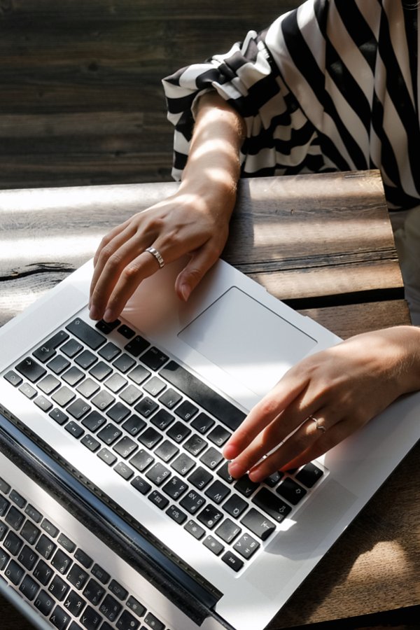 A laptop and a hand