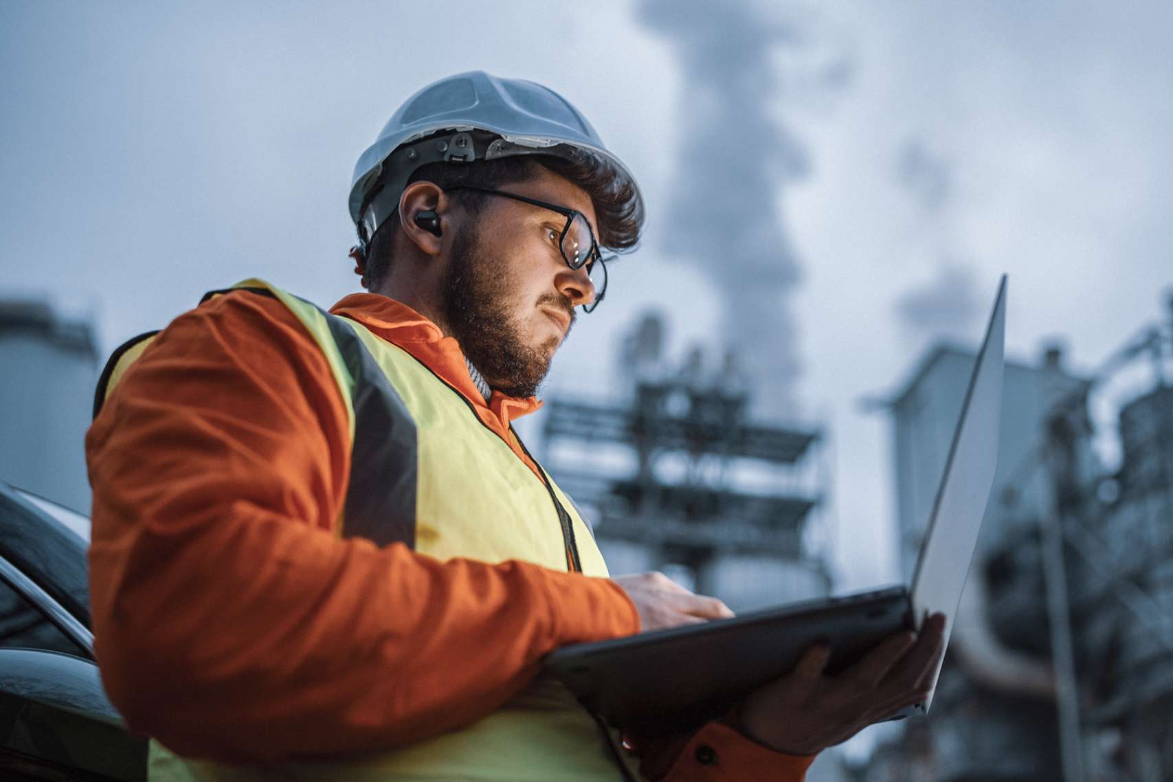 Engineer using a laptop while working in the oil and gas industry