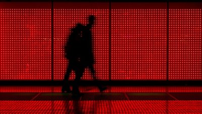 People in silhouette in a red background