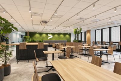 An Accenture office with bunch of brown table and brown chairs