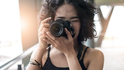Close Up Photo of a Woman Holding a Camera