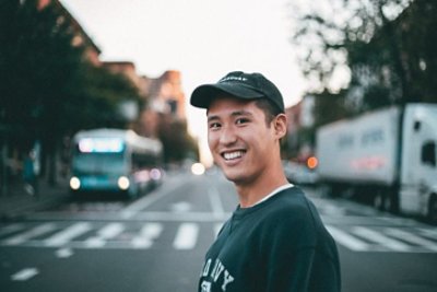 Man smiling in the middle of the road