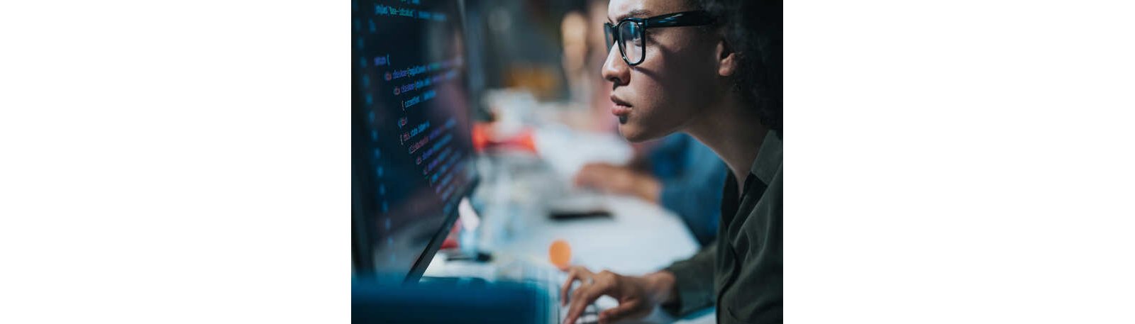 A man with glasses programming