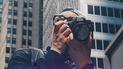 Close Up Photo of a Man Holding a Camera