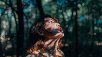 Image of a girl heads up on a forest 