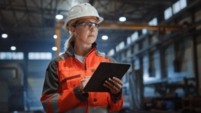 Woman Wearing Safety Gear Holding Tablet 724x407 JPEG