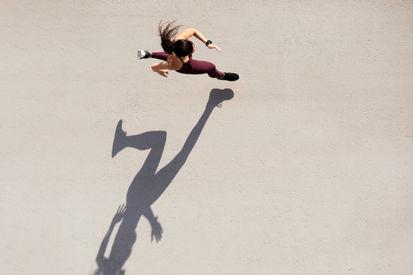 Sprinter seen from above with shadow and copy space