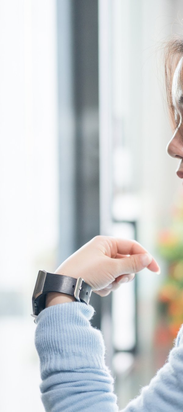 Young asian businesswoman using smart watch unlock door