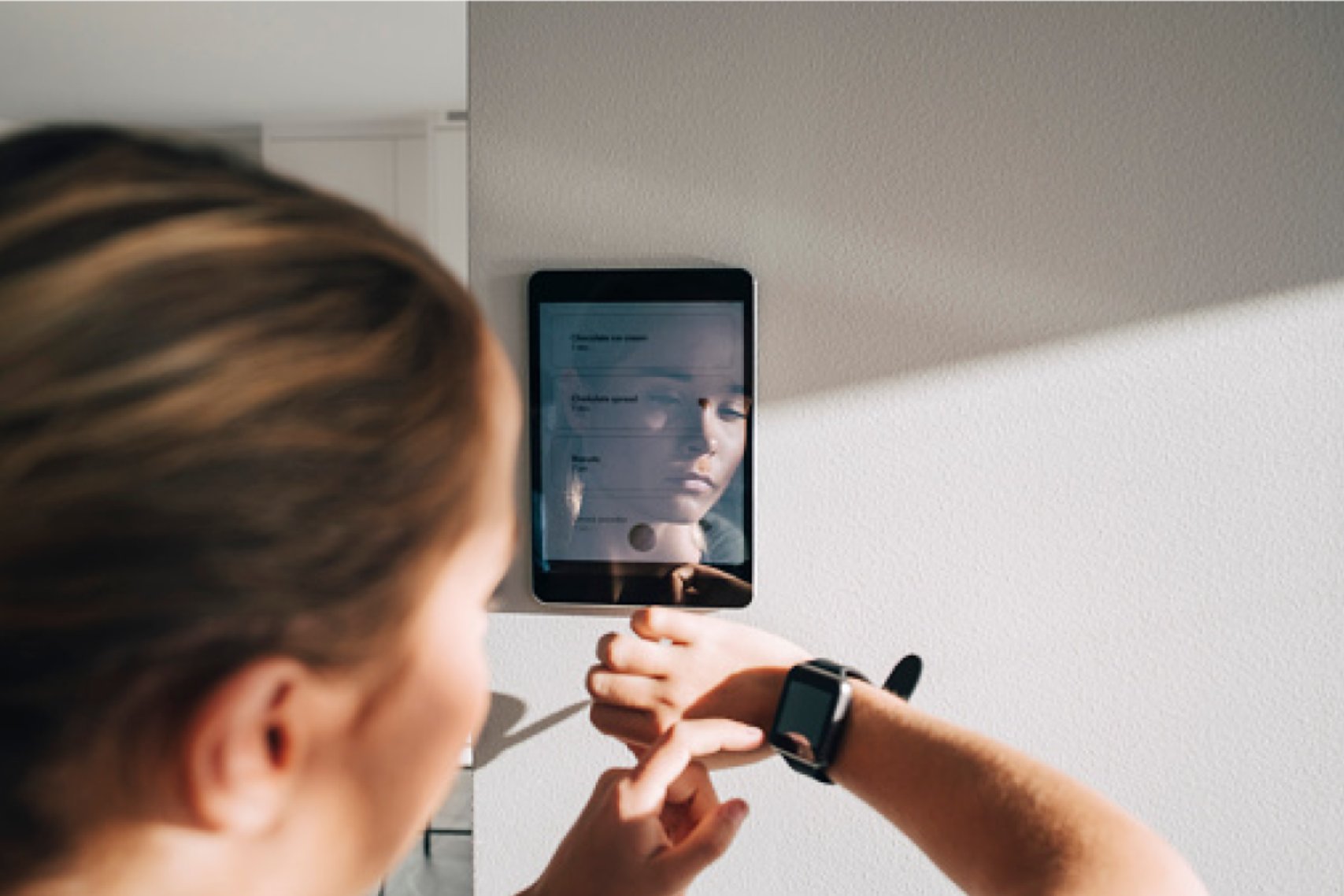 A woman looking at her smartwatch