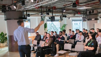 man giving lecture on the front of student in a room