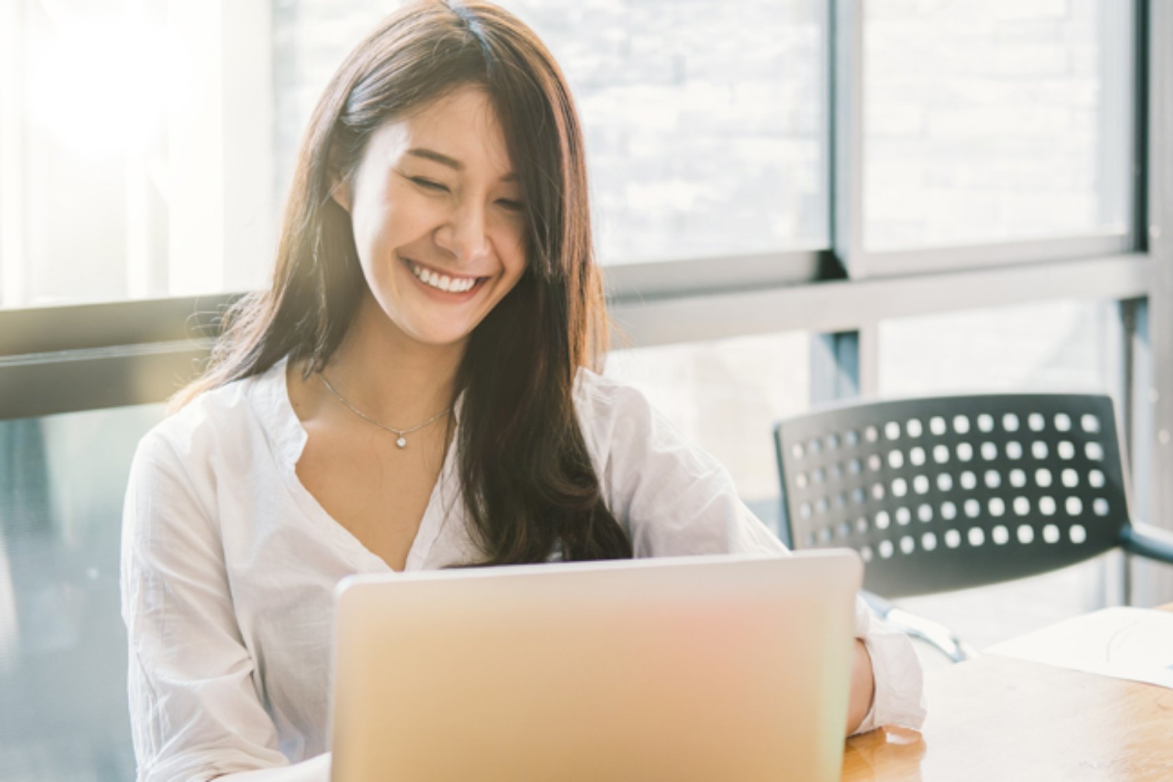 Portrait Of Attractive Asian Businesswoman Working On Laptop For Marketing Plan