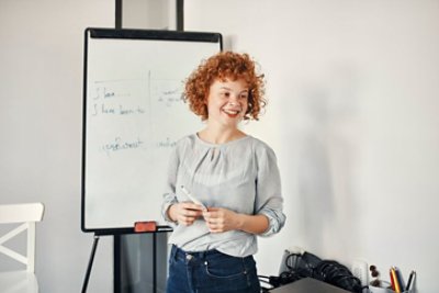 A woman exposing with a white board