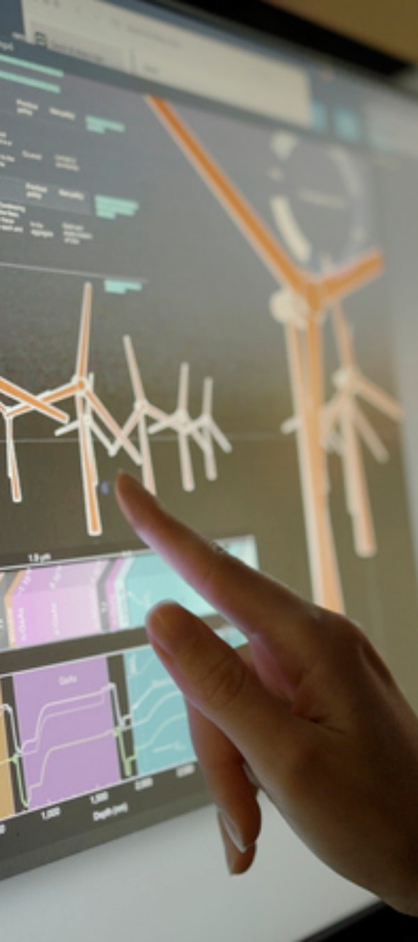 Stock image showing a woman’s hand using a touch screen monitor. The monitor displays data, images & moving graphics associated with climate change & the woman’s hand swipes images to change them.