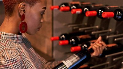 Woman inspecting in the wine cellar.