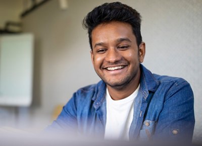 a guy wearing blue denim smiling