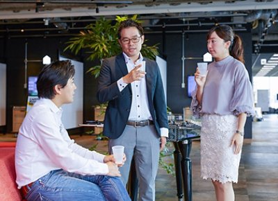 Three People Talking Inside the Office