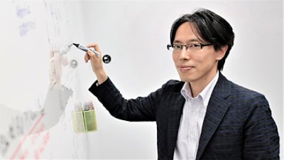 Man holding a pen writing on whiteboard