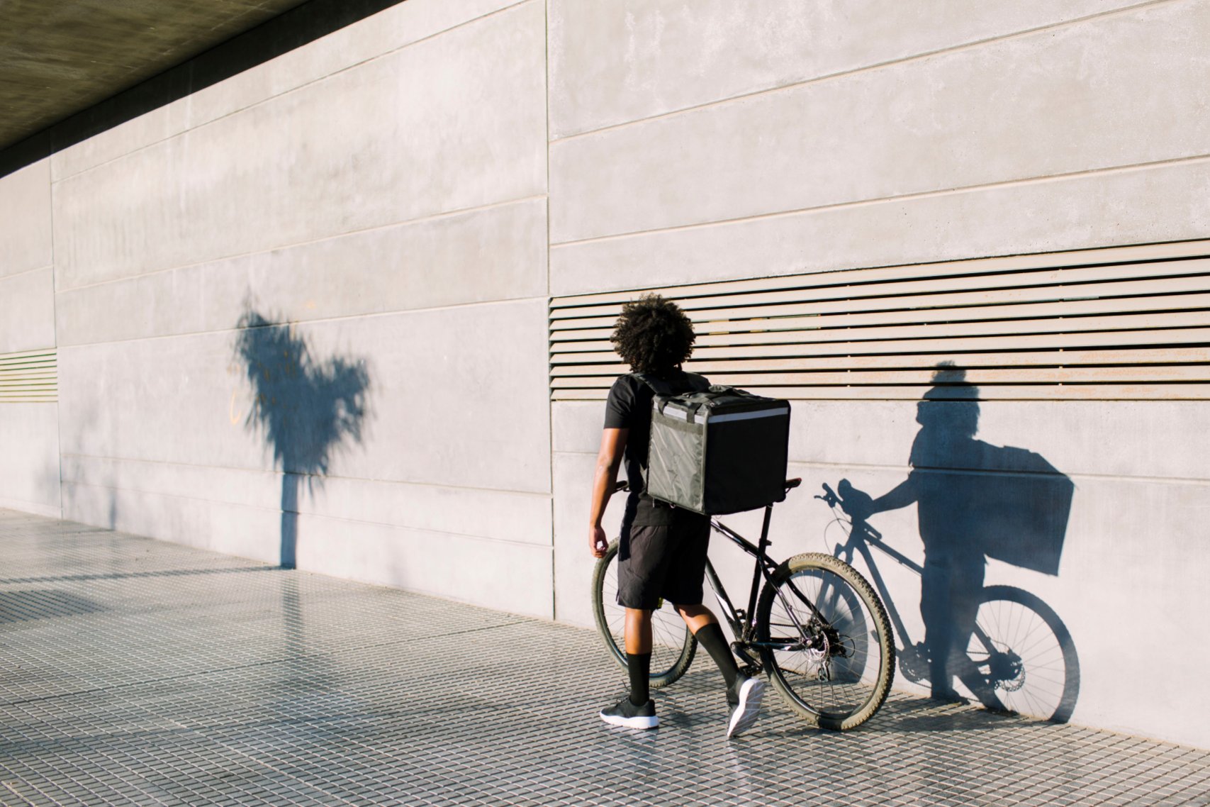 Man dragging a bicycle