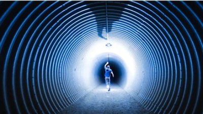 The image shows a person walking through a tunnel with tags light and shadow