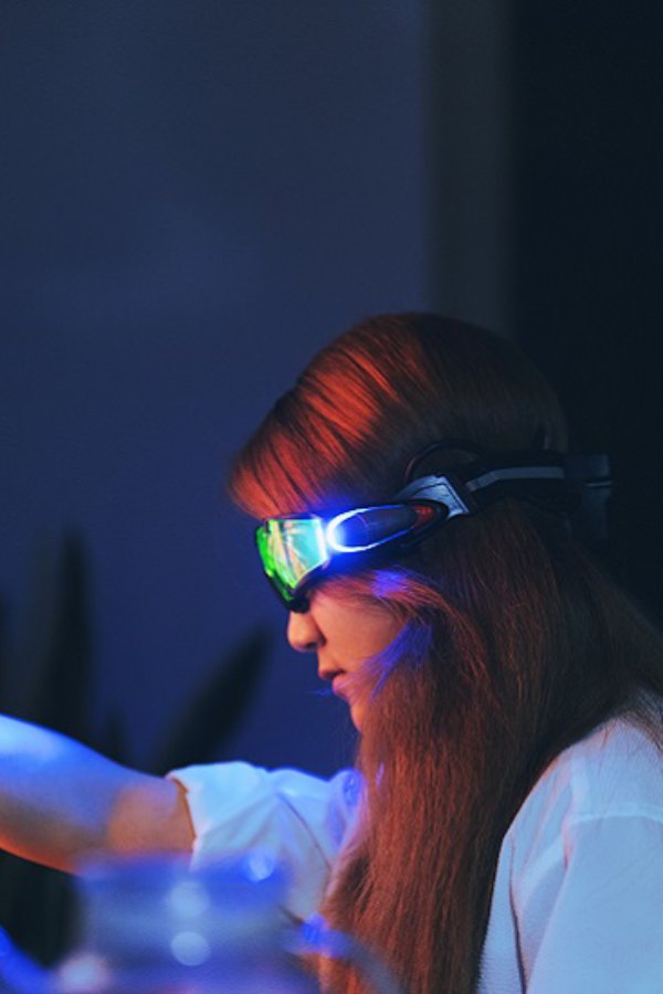 Woman wearing augmented reality glasses touching the screen with hands