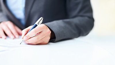 Businesswoman's hands signing a contract 