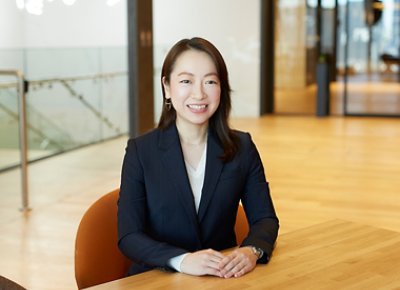 woman sitting with hand on top of the table