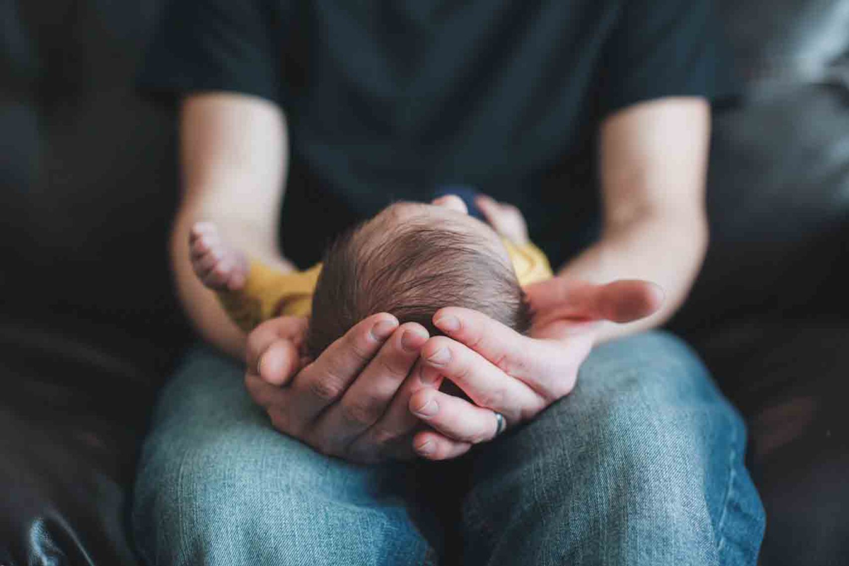 A parent holding his baby