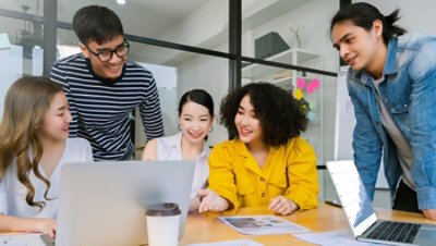 Five people looking at a laptop