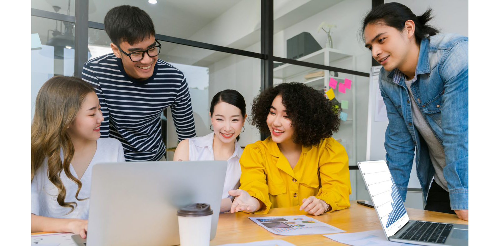 Five people looking at a laptop