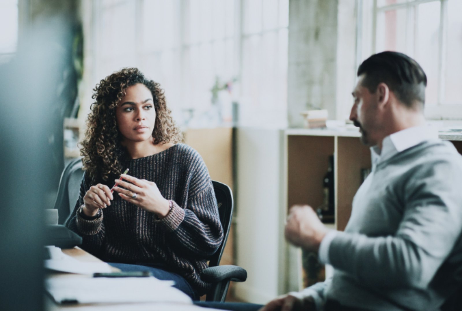 Woman and man discussing in office