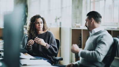 Woman and man discussing in office