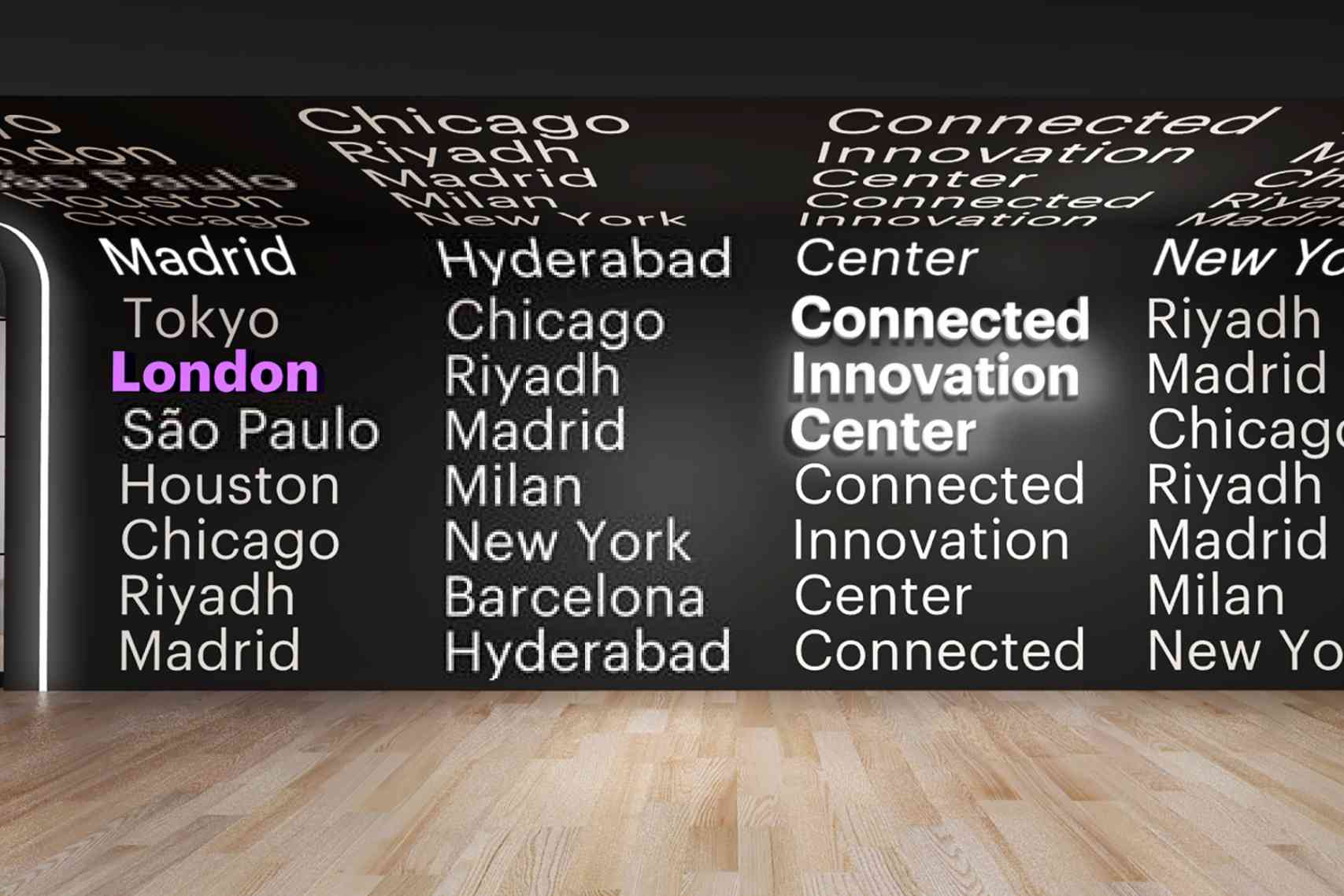 Image of a room with lights reflecting off the wall with city names.